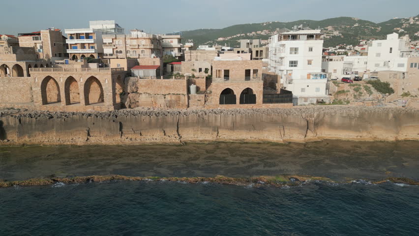 Drone video capture showcase an ancient Phoenician protective wall erected on the shore of Mediterranean sea in the town of Batroun, Lebanon.