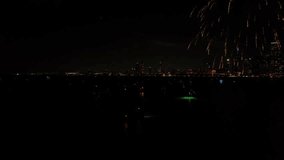 Bursts of holiday fireworks over the urban Chicago downtown city skyline and the dark reflective waters. - Powered by Shutterstock - Get 15% off with code: PIKWIZARD15