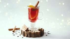 Warm winter drink mulled wine with orange and cinnamon sticks in glass mug decorated with spices. - Powered by Shutterstock - Get 15% off with code: PIKWIZARD15