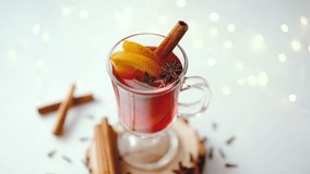 Warm winter drink with orange slices, cinnamon sticks, and star anise on wooden base - Powered by Shutterstock - Get 15% off with code: PIKWIZARD15