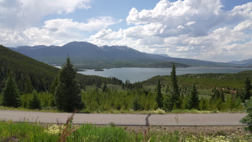 Guy skates down asphalt trail of Sapphire Point overlooking Dillon Reservoir