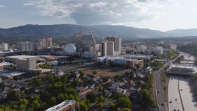 Aerial view of Reno, Nevada, at sunset with casino skyline, National Bowling Stadium, Sierra Nevada mountains, and active highway traffic below. - Powered by Shutterstock - Get 15% off with code: PIKWIZARD15