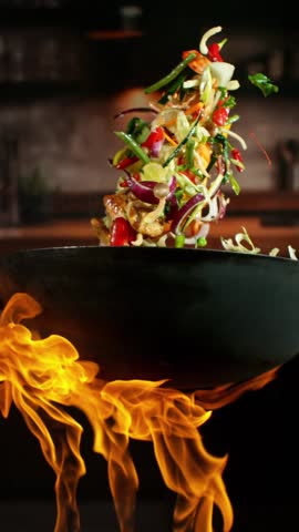 Super Slow Motion of Flying Asian Wok Ingredients . Filmed on High Speed Cinema Camera