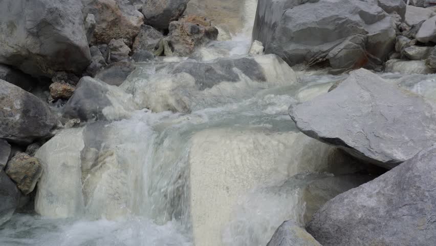  Milky Waterfall Cascade Whitewater Flows Over Gray Rocks in Mountain Stream.