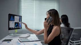 Confident businesswoman analyzing financial charts while discussing strategy on smartphone during client call in contemporary corporate workspace - Powered by Shutterstock - Get 15% off with code: PIKWIZARD15