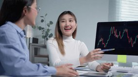 Two young businesswomen are discussing a candlestick chart displayed on a computer screen, analyzing market trends and investment strategies - Powered by Shutterstock - Get 15% off with code: PIKWIZARD15