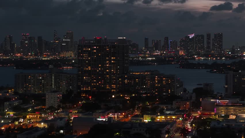 Miami Cityscape Skyline at Night, Aerial View of Downtown and Miami Beach Buildings and Streets in Lights, Florida USA