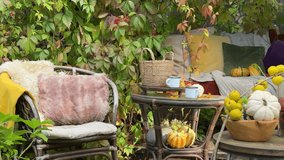 Rustic autumn still life with pumpkins, berries, cozy blankets, and fall leaves in a garden swing corner. Hygge outdoor seasonal decor with natural textures and colorful foliage - Powered by Shutterstock - Get 15% off with code: PIKWIZARD15