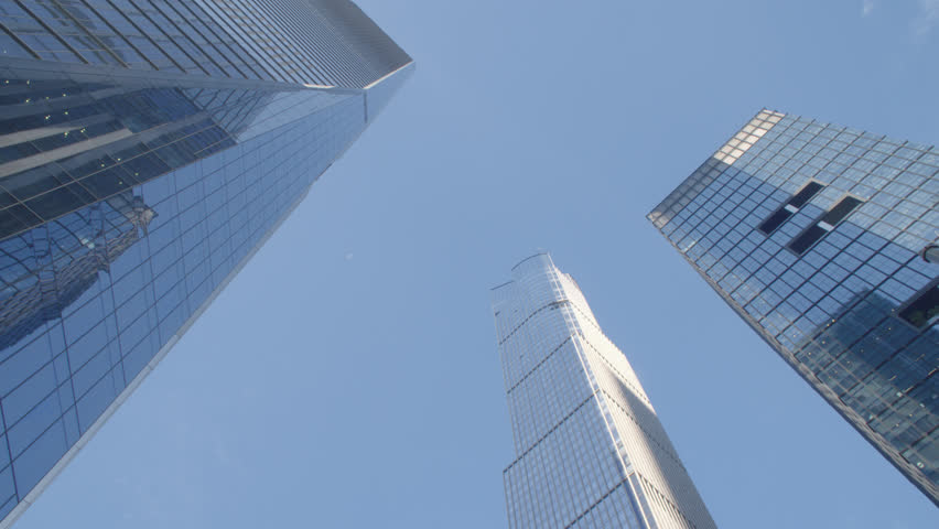 Looking up at Manhattan skyscrapers from the streets below. Shot on a summer morning in New York City.