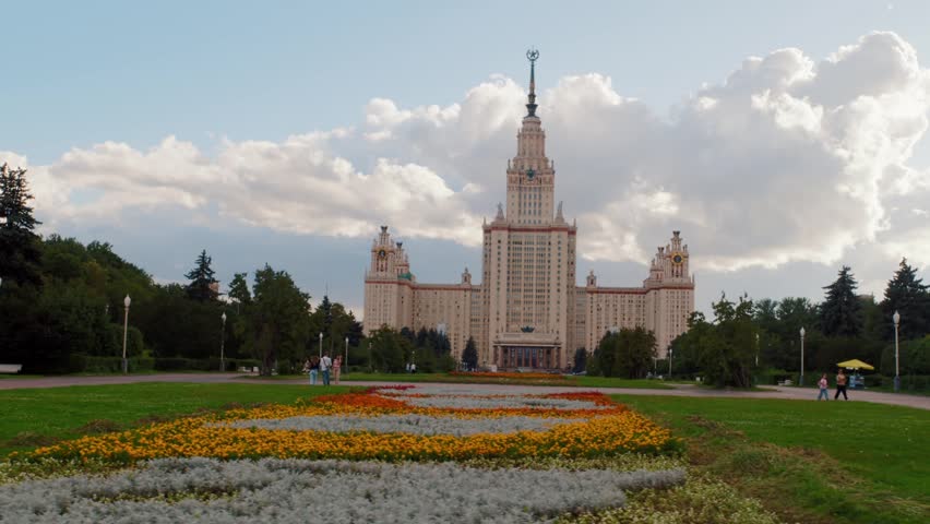 Historic university building with flower bed in front