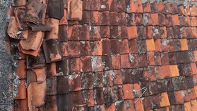 Old clay roof tiles with weathered surface, showing moss, lichen, and natural aging patterns on traditional roofing. - Powered by Shutterstock - Get 15% off with code: PIKWIZARD15