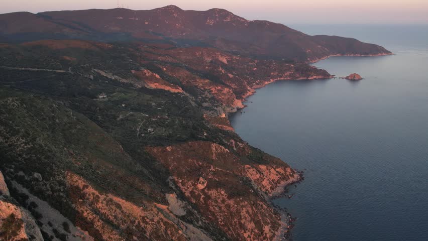 Drone view of the coast of Torre di Capo d'Uomo on Mount Argentario near Porto Santo Stefano during sunset (Grosseto, Tuscany, Italy).