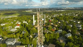 Aerial drone footage orbiting and flying around a large modern radio or tv network broadcasting tower with 4G, 5G and even 6G vidgets and technology mounted on it during a sunny summer day in horizon. - Powered by Shutterstock - Get 15% off with code: PIKWIZARD15