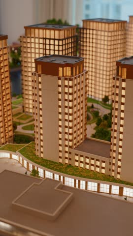 Architectural model of modern residential skyscrapers with green courtyards