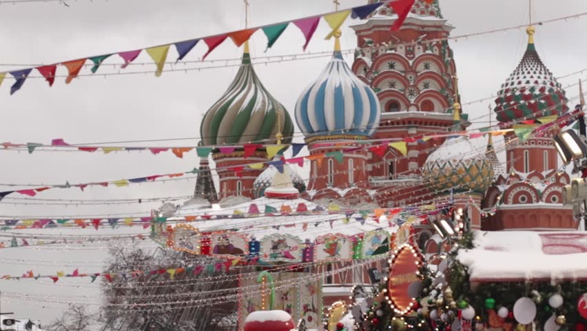 Christmas fair in winter on Red Square in Moscow, xmas market with festive lights and pine decor, people enjoying winter tourism and magical evenings.