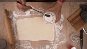 woman Preparing Dough sprinkling sugar on a Wooden Surface. Baking Steps. Top view. - Powered by Shutterstock - Get 15% off with code: PIKWIZARD15