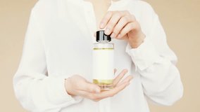 A woman holding a cosmetic bottle, showcasing beauty and skincare product packaging for advertising and branding. - Powered by Shutterstock - Get 15% off with code: PIKWIZARD15