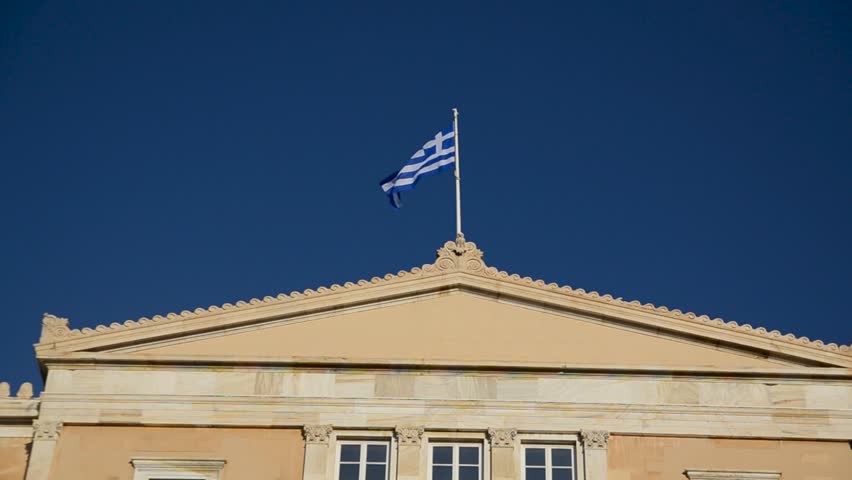 Athens, Greece: Building of Hellenic Parliament. Flag of Greece at the Parliament of Greece. Old Royal Palace on Syntagma square, the current seat of the Greek Parliament. 