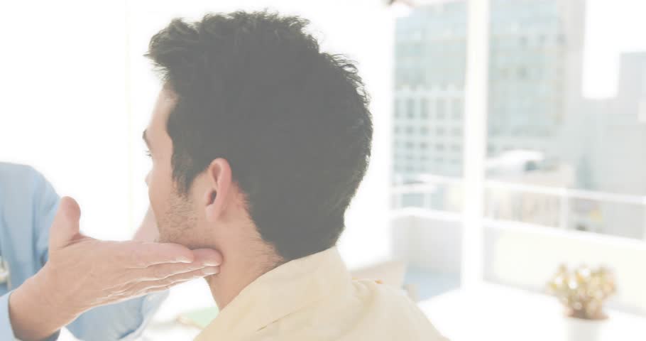 Doctor placing hand under chin palpating neck with HUD overlays for medical exam while tilting head. Medical, healthcare, diagnostic, urban, modern, continuous monitoring, professional
