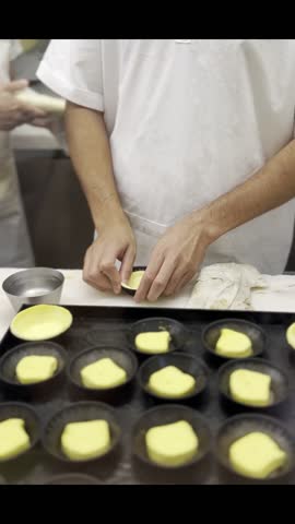 Close-up footage of a professional chef skillfully preparing pastel de nata, a beloved traditional Portuguese custard tart