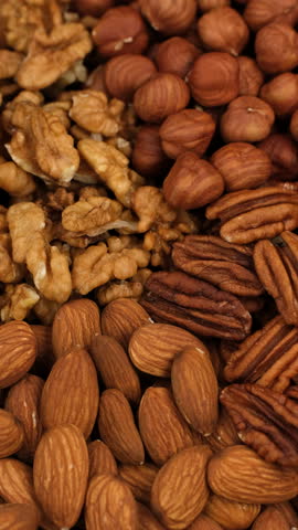 Heap of different nuts, rotation. Healthy vegan snack for everyone