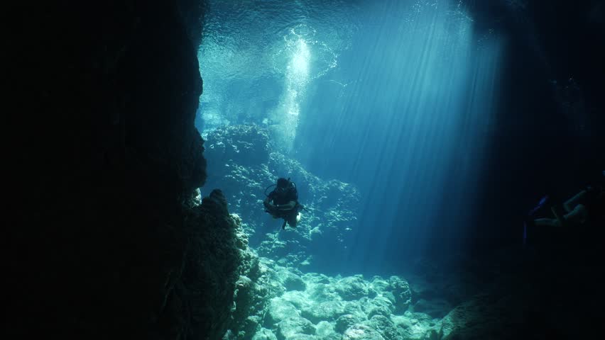 scuba divers are exploring caves underwater