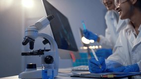 Two female scientists discussing test results displayed on a computer screen in a modern laboratory - Powered by Shutterstock - Get 15% off with code: PIKWIZARD15