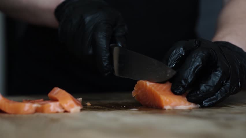Chef Cutting Fresh Salmon for Sushi with Sharp Knife