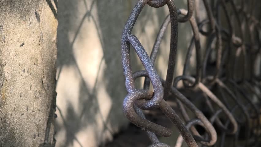 wire fence. chain link mesh. rusty iron fence. old rusty cage. symbol of freedom. symbols of imprisonment. chain link fence