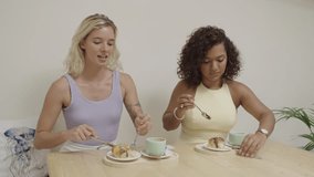 Happy female friends eating delicious pastries in a cafe - Powered by Shutterstock - Get 15% off with code: PIKWIZARD15