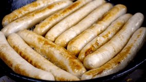 Sausages fry in a hot cast iron skillet, revealing a delicious golden-brown crust. Captivating cooking technique highlights mouthwatering details. - Powered by Shutterstock - Get 15% off with code: PIKWIZARD15