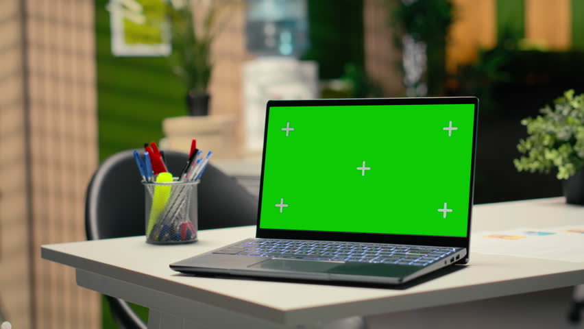 Mockup screen on laptop running chroma key in an empty business workspace, human resources department office space prepared for hiring process, interviews and career development. Chroma key.