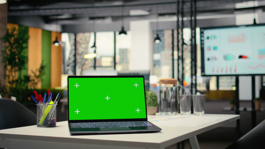 Mockup screen on laptop running chroma key in an empty business workspace, human resources department office space prepared for hiring process, interviews and career development. Chroma key.