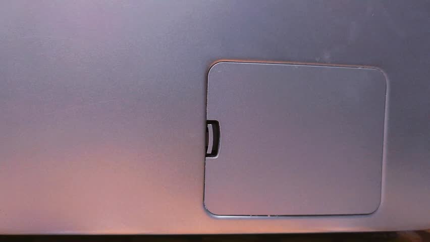 Washing machine filter cover. A person opens the filter cover with his hand. Close-up.	
