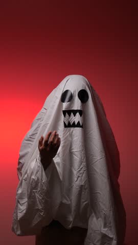 vertical video Ghost costume holding hand out for candy