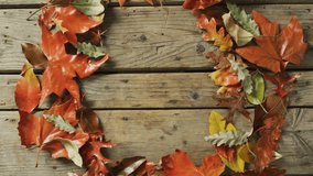 Launching greeting screen showing wood plank with autumn leaves framing Happy Thanksgiving text. Rustic, fall, seasonal, nature, celebration, warm, inviting - Powered by Shutterstock - Get 15% off with code: PIKWIZARD15