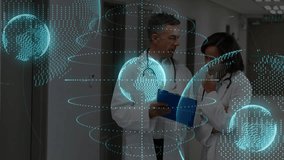 Holographic globes rotating around doctors reviewing chart on clipboard for health data analysis. Medical professionals, collaboration, digital technology, healthcare, data visualization, clinical - Powered by Shutterstock - Get 15% off with code: PIKWIZARD15