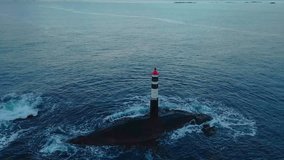 aerial footage showcasing a solitary lighthouse standing firm amidst powerful ocean waves. This dramatic scene highlights the resilience of the structure against the forces of nature, with the vast ex - Powered by Shutterstock - Get 15% off with code: PIKWIZARD15