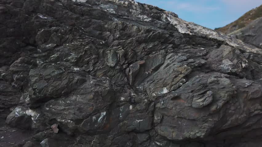 Waves roll onto sandy shore at Baker Beach with Golden Gate Bridge in background, San Francisco, California, USA. Iconic coastal view with ocean, rocks and Marin Headlands
