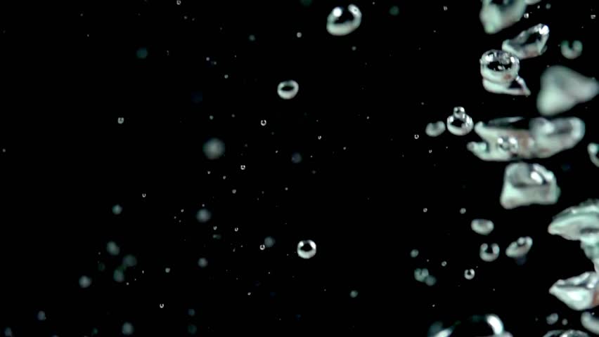 Multiple clear bubbles move upwards against simple dark background. Nice texture element for overlays, graphics, and Visual Effects.