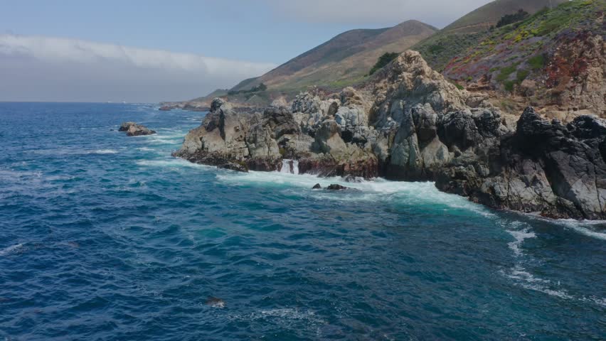 Big Sur California USA video footage of rugged Pacific coastline along Highway 1 with dramatic rocky cliffs, crashing ocean waves, and scenic seascape view of the wild California coast