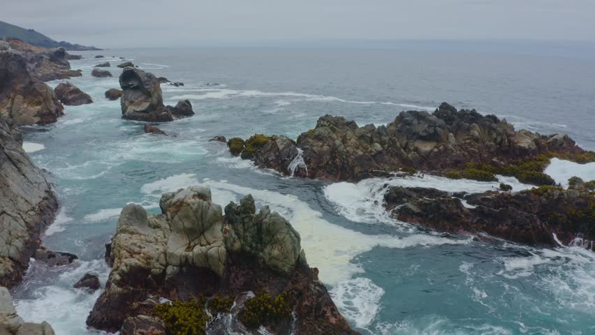 Big Sur California USA video footage of rugged Pacific coastline along Highway 1 with dramatic rocky cliffs, crashing ocean waves, and scenic seascape view of the wild California coast
