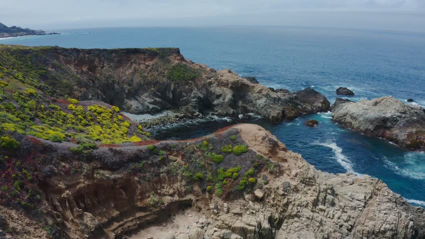 Big Sur California USA video footage of rugged Pacific coastline along Highway 1 with dramatic rocky cliffs, crashing ocean waves, and scenic seascape view of the wild California coast