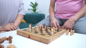 Senior couple playing chess together at home, enjoying leisure time and mental exercise - Powered by Shutterstock - Get 15% off with code: PIKWIZARD15