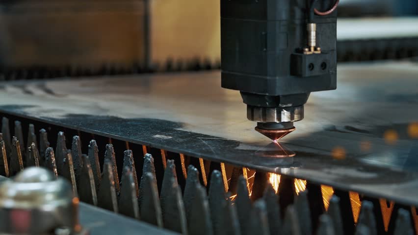 Industrial CNC laser cutting machine processing metal sheet with bright sparks and plasma light. High precision manufacturing technology in modern metalworking industry. Tech Background Close-up 4k