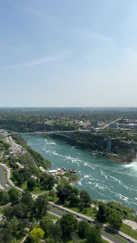 PAN SLOW - The American Falls and Bridal Veil Falls, the U.S. Customs and Border Protection – Rainbow Bridge Port of Entry, and the Prospect Point Observation Tower in Niagara Falls, Ontario, Canada.