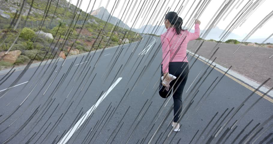 After completing quadriceps stretch, woman initiating steady walk along highway for fitness goal. Fitness, outdoor, activity, determination, minimalist, adventure, health