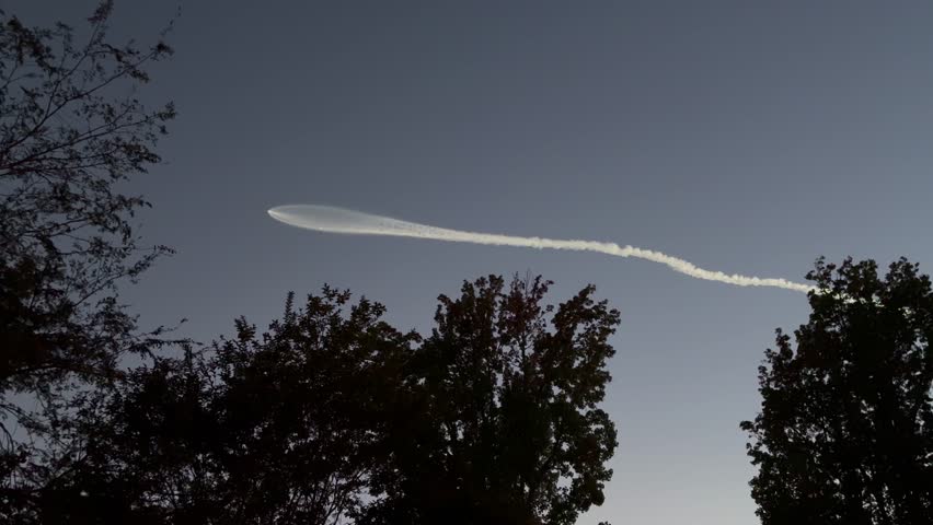 A Jet Leaving a Plume of Smoke in the Night Sky
