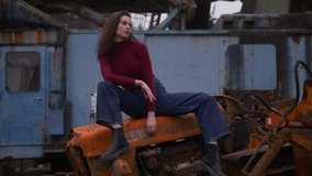 Old rusty tractor photoshoot featuring a model in a vintage setting - Powered by Shutterstock - Get 15% off with code: PIKWIZARD15