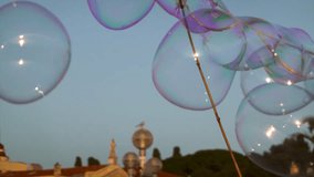 Colorful soap bubbles floating against the blue evening sky during a street performance - Powered by Shutterstock - Get 15% off with code: PIKWIZARD15